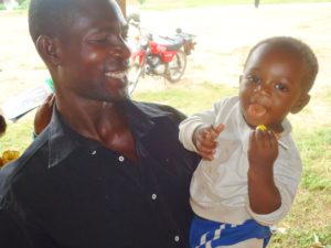 A happy father and son after seasonal malaria chemoprevention treatment in Ghana