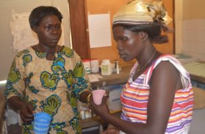 A pregnant woman receives her IPTp drugs from a health worker in West Nile, Uganda